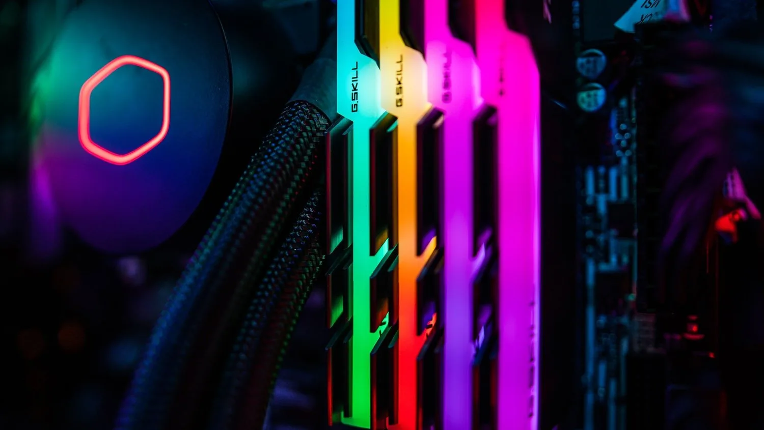 Close-up of RGB-lit memory modules and a liquid cooler inside a computer